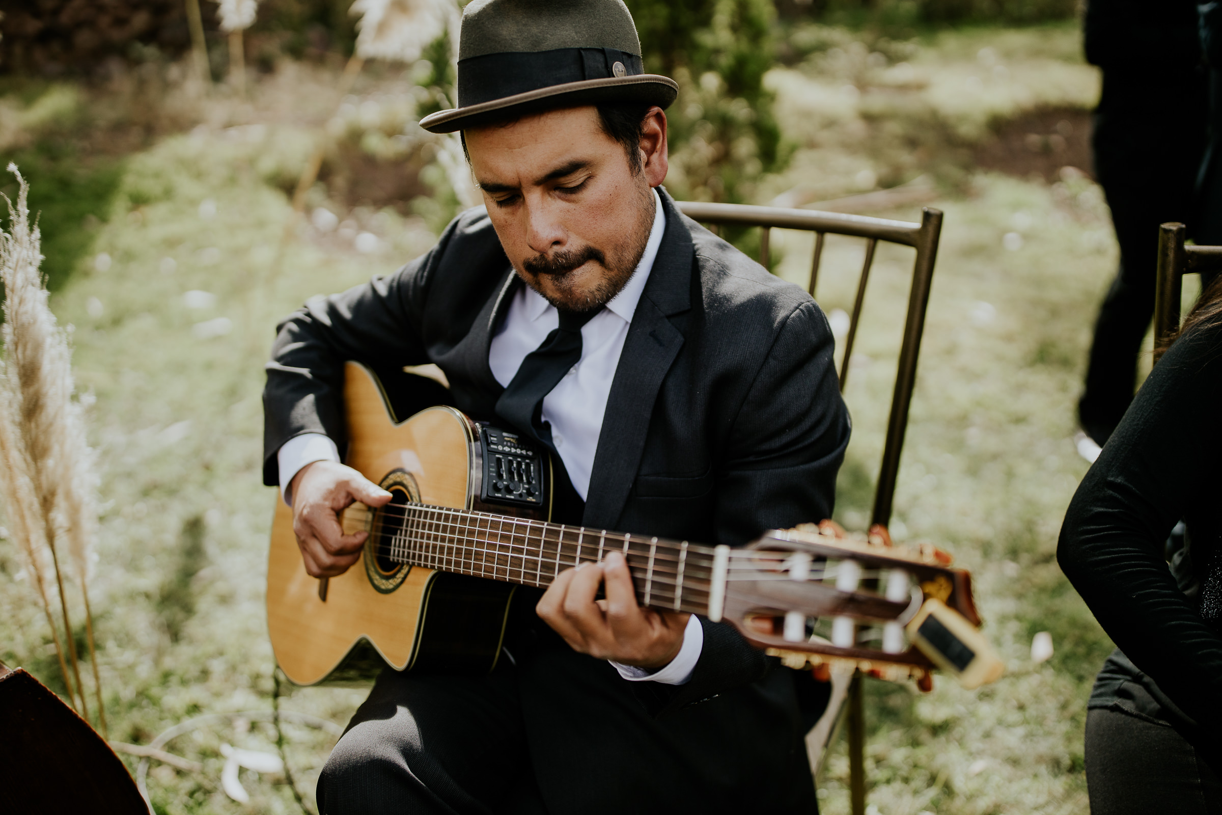 man playing guitar at a wedding ceremony