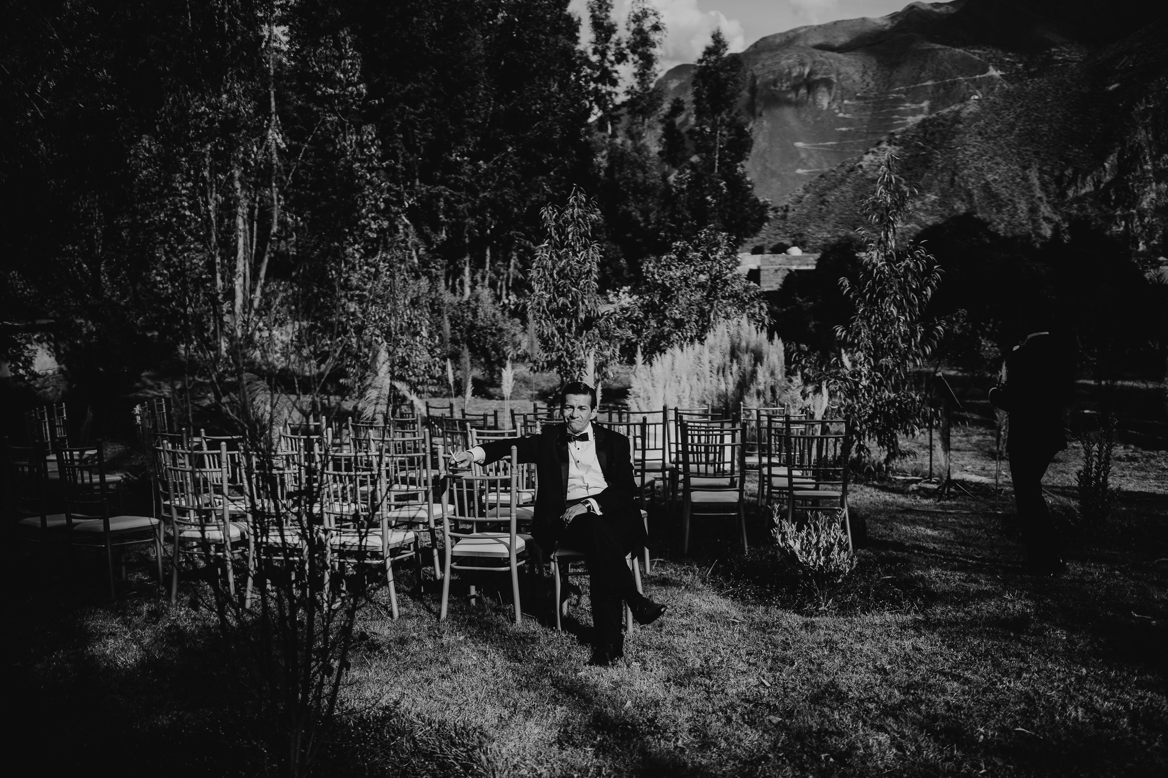 man sitting alone at a wedding ceremony set up