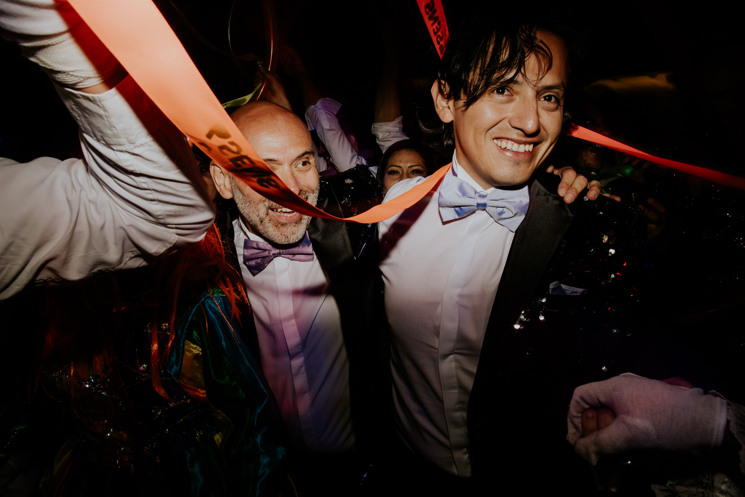 two men having fun at a wedding wild party