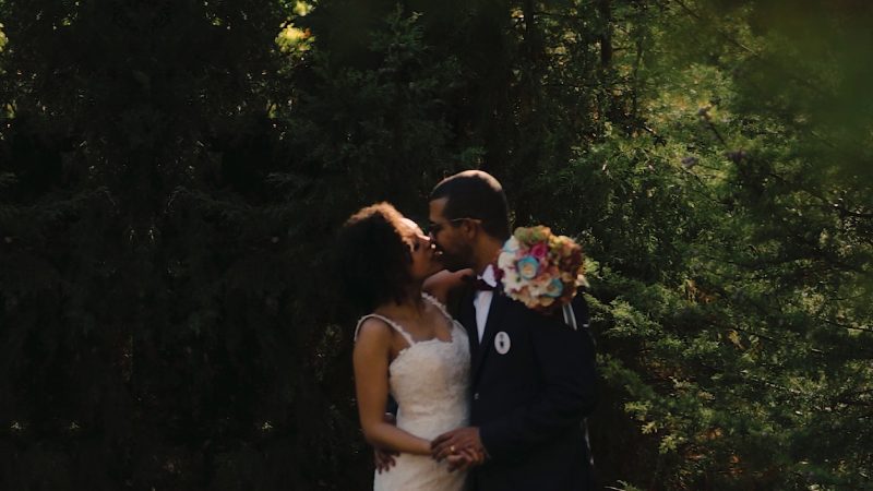 bride and groom embracing in the woods